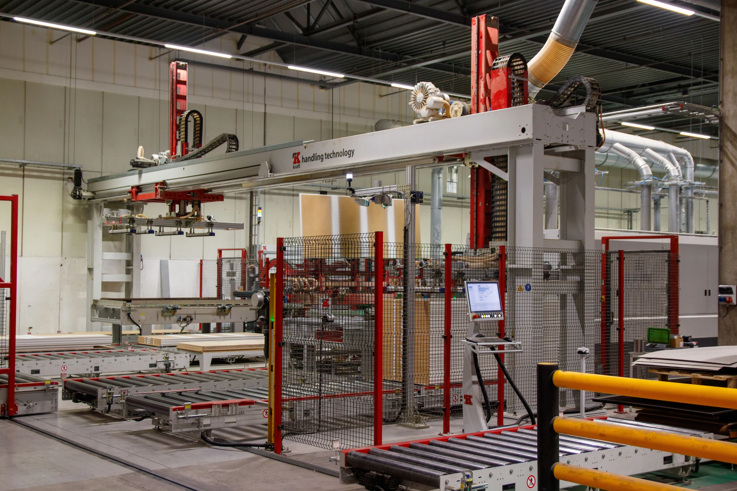 Automated gantry and conveyor equipment within a factory safety enclosure