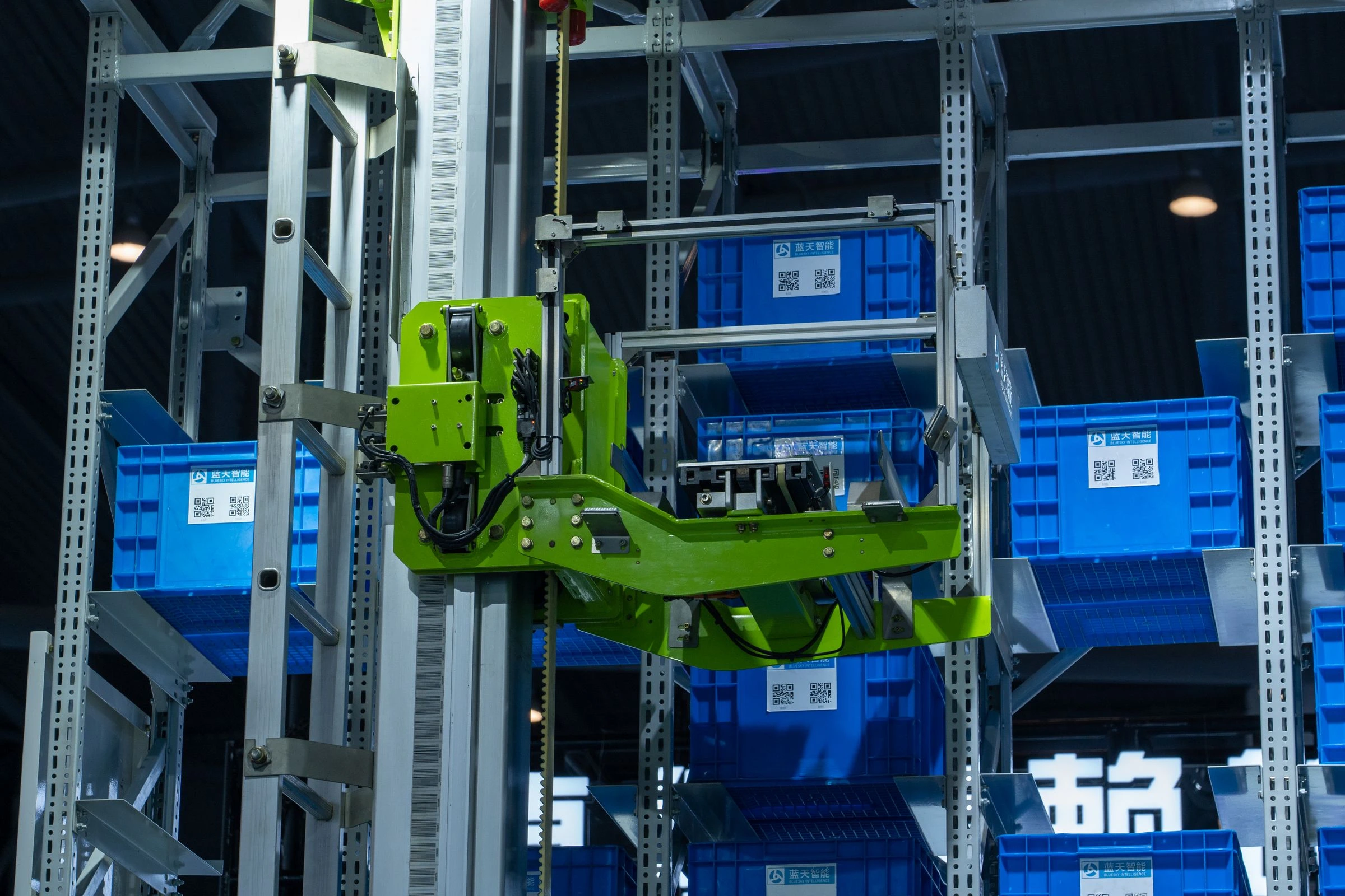 Automated storage equipment retrieving blue crates from a high-density rack
